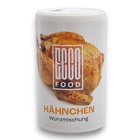 Weißes zylinderförmiges behältnis mit goco food hähnchen würzmischung 150g und geröstetem hähnchenbild umgeben von kräutern