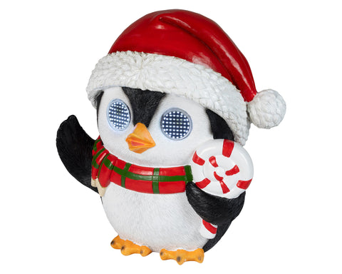 Ein festlicher schwarz-weißer led-pinguin außen mit kaltweißen led 19x26x28,5 cm in santa-mütze und kariertem schal