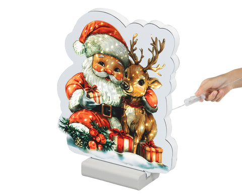 Ein festliches beleuchtetes weihnachtsschild mit vintage-weihnachtsmann und rentier in rot, weiß und gold mit warmweißen leds