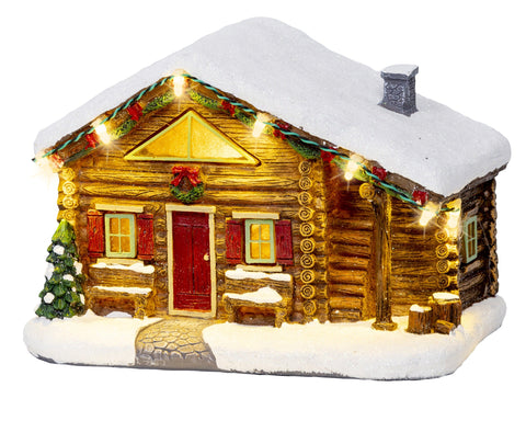 Festliche beleuchtete schneehütte figurine mit schneebedecktem dach und roter tür in warmweißer led szene
