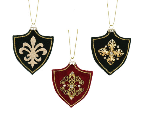 Three ornamental shield-shaped christmas velvet ornaments with gold fleur-de-lis embroidery in black and red
