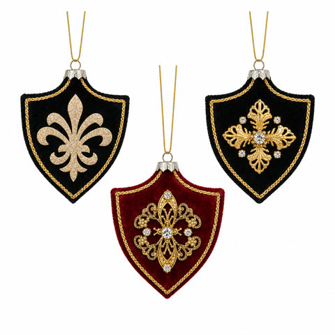 Three ornamental shield-shaped christmas velvet ornaments with gold fleur-de-lis embroidery in black and red