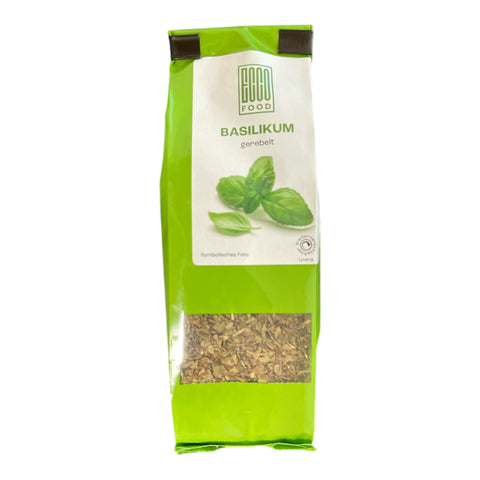 Bright green bag of hacco dried basil labeled basilikum gerebelt with clear window showing chopped herb inside