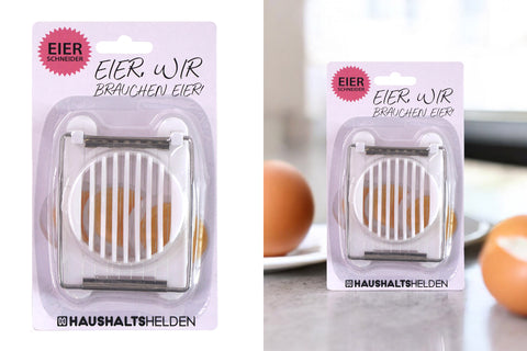Weißer eier schneider aus kunststoff mit metallklingen in verpackung für gleichmäßiges eierschneiden