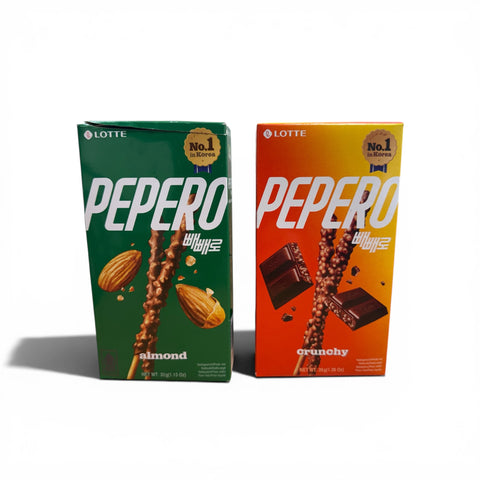 Zwei pepero schokolierte keks-sticks in grüner mandel- und oranger knusprig schokoladengeschmack-verpackung