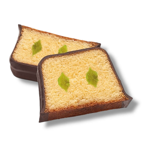 Two scheiben goldener schokolierter kiwi-kuchen mit dunkler schokoladenumrandung und grünen gelee blatt garnierungen