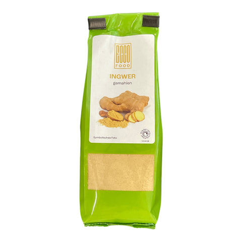 Grüner bright green pouch von goo food mit ingwer gemahlen und durchsichtigem fenster zeigt das gelbliche gemahlene ingwerpulver