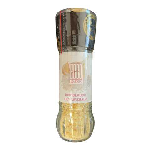 Ein schlanker knoblauch gewürzsalz grinder aus glas mit schwarzem deckel und goldgelben körnern 55g