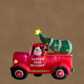 Aufblasbarer roter lastwagen mit led santa claus fahrer und weihnachtsbaum ladung mit text santas tree delivery