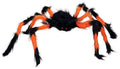 Eine plüschige schwarz-orange spinne 75 cm mit flauschigen beinen und leuchtend roten augen