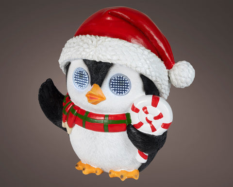 Led pinguin außenfigur weiß schwarz mit rotem weihnachtshut hält zuckerstange mit kaltweißen leds