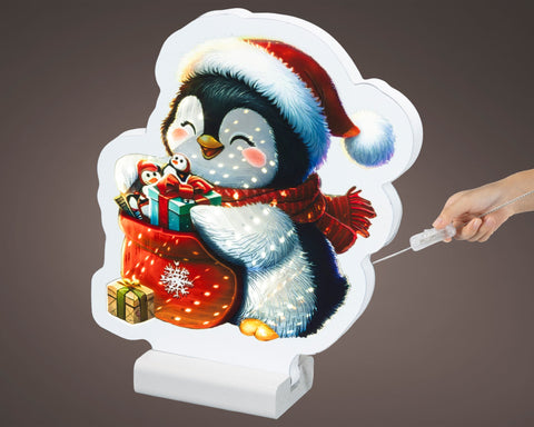 Led infinity pinguin warmweiße led beleuchtung mit schwarzem weißem cartoon pinguin und leuchtendem geschenksack