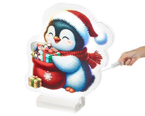 Ein festlicher led infinity pinguin aus warmweißen leds trägt eine santa mütze und hält einen geschenkesack