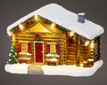 Cozy log cabin figurine with warm white led lights snow-covered roof and red door 12x18.5x12.5cm