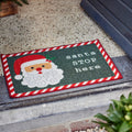 Grüne fussmatte aus nylon 40x60x0,5 cm mit weihnachtlichem glitzernden santa gesicht und zuckerstangenrand