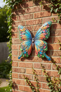 Vibranter metallschmetterling wandaufhänger 46x50cm mit mehrfarbigen wirbelmustern in blau grün orange und rosa