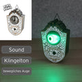 Spooky weiße und goldene animierte türklingel gruselauge mit leuchtendem grünem auge 18 cm groß