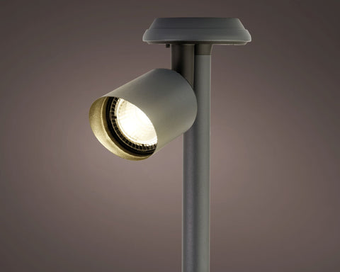 Grauer zylindrischer solar spotlight edelstahl mit warm leuchtender birne und metallischem rand für dauerbetrieb