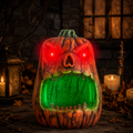 Beißende kürbis-bonbonschale 33 cm mit leuchtend orangefarbenem körper, roten led-augen und grün beleuchtetem mund mit scharfen zähnen