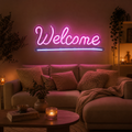 Led-schild neon welcome mit pinkem leuchtschriftzug in eleganter kursivschrift und blauem unterstrich