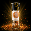 Eine klare glas-pfeffermühle chili gewürzsalz mit schwarzem deckel goldenen akzenten gefüllt mit roten chiliflocken