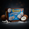 Braune und blaue box mit cravingz cocomallow kuchen 100g und kokosnussgrafiken auf der verpackung