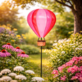 Ein metall gartenstecker heiluftballon 65x18 cm in rosa mit lebendigem pink-rot und geflochtenem korbständer