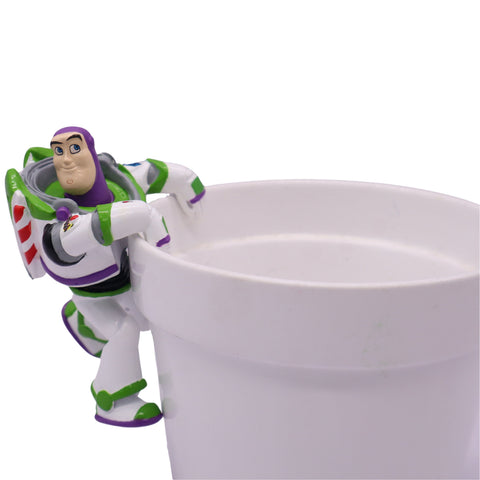 Topf buddy buzz lightyear plastikfigur in lila, grün und weiß, die an der seite einer tasse hängt