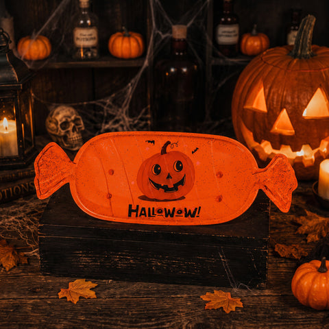 Orange candyförmige halloween schale mit lächelndem kürbisdesign und halloween text für süßigkeiten