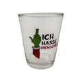 Klare glasschnapsglas mit grünem cartoonhandzeichen in rotem ärmel und text ich hasse menschen für festtagsmuffel