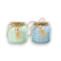 Two sea-themed glass jars with cork lids and twine ties in mint green and light blue with anchor tags for maritime decor