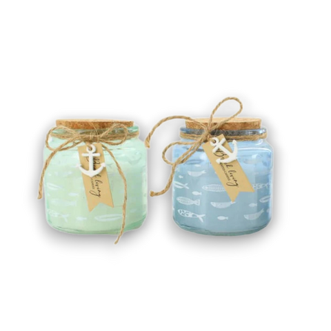 Two sea-themed glass jars with cork lids and twine ties in mint green and light blue with anchor tags for maritime decor