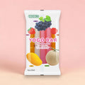 Ein weißes paket cocon yogo bar mit milch und saft und bunten obstillustrationen wie trauben erdbeeren mango und honigmelone trägt den titel yogo ice stäbchen 450ml