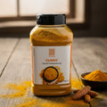 Ein klarer plastikbehälter mit schwarzem deckel enthält leuchtend orange curry pulver von coco food gewürzt