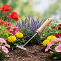 A sleek silver metal harke am holzstiel 30cm with light wooden handle in soil among red poppies and purple lavender