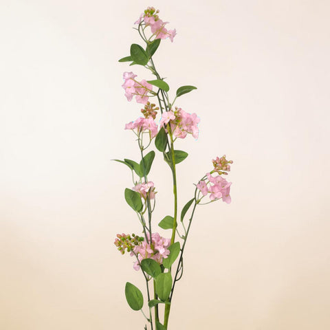 Ein künstlicher kunstzweig apfelblüte mit zarten rosa blüten und glänzenden grünen blättern